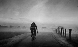 Cyclist In The Morning Mist